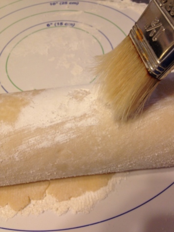 Brush off excess flour